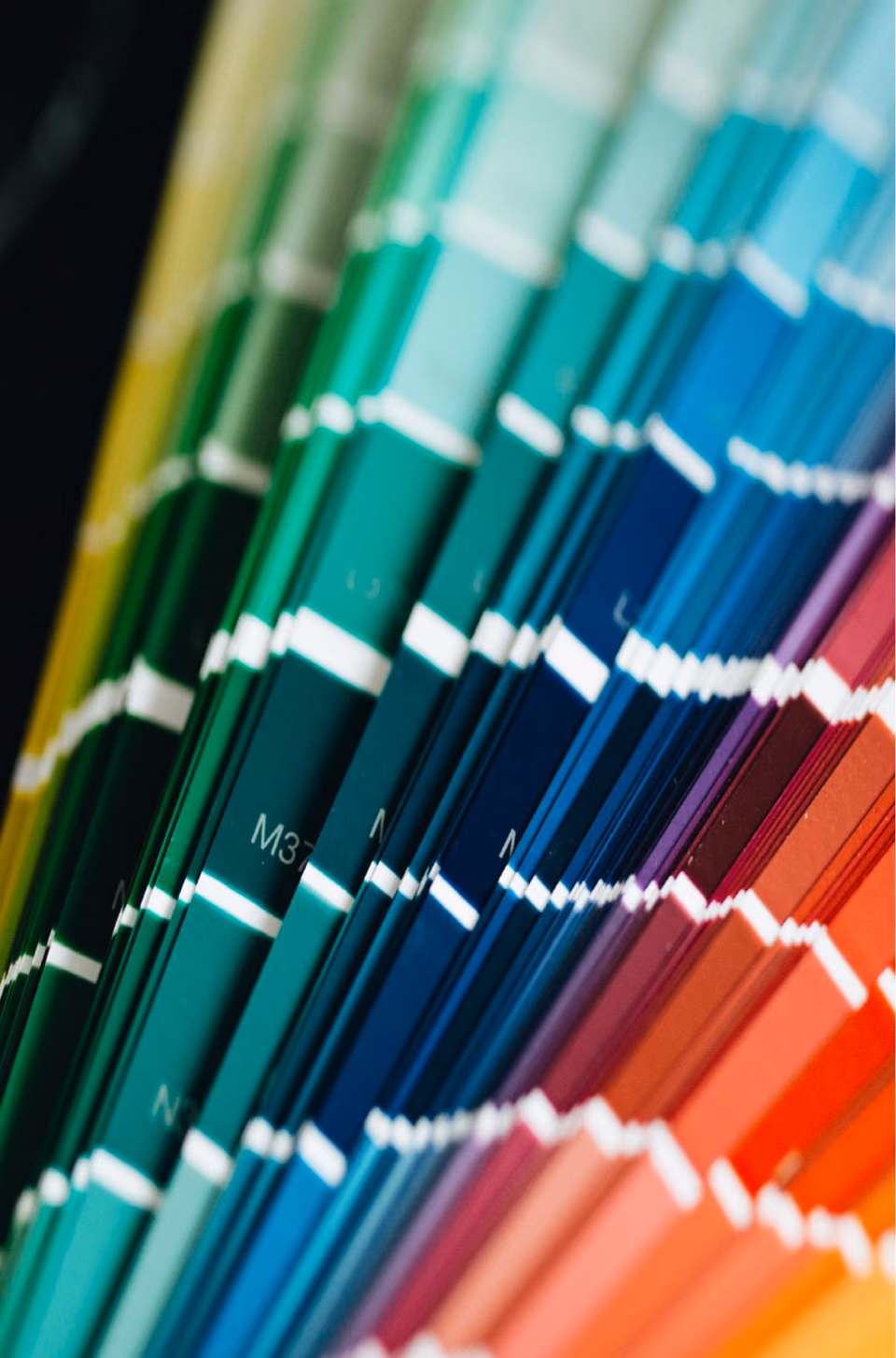 Fan of solid color samples ranging from green and blue to red and orange