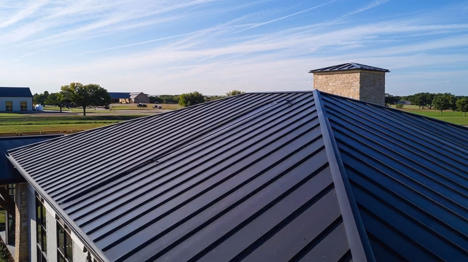 A completed building roof made from dark prepainted steel panels